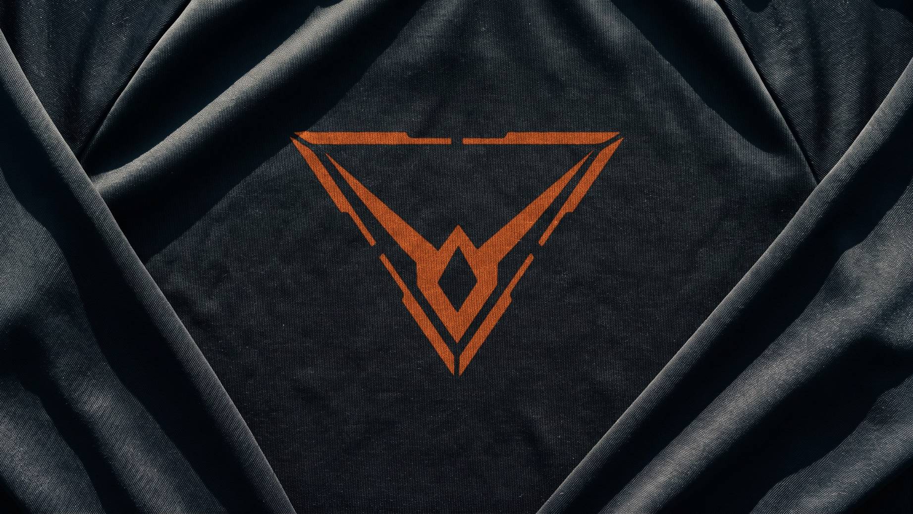 A render of black training jersey in raking sun, the orange Hypereon mark printed large across the chest