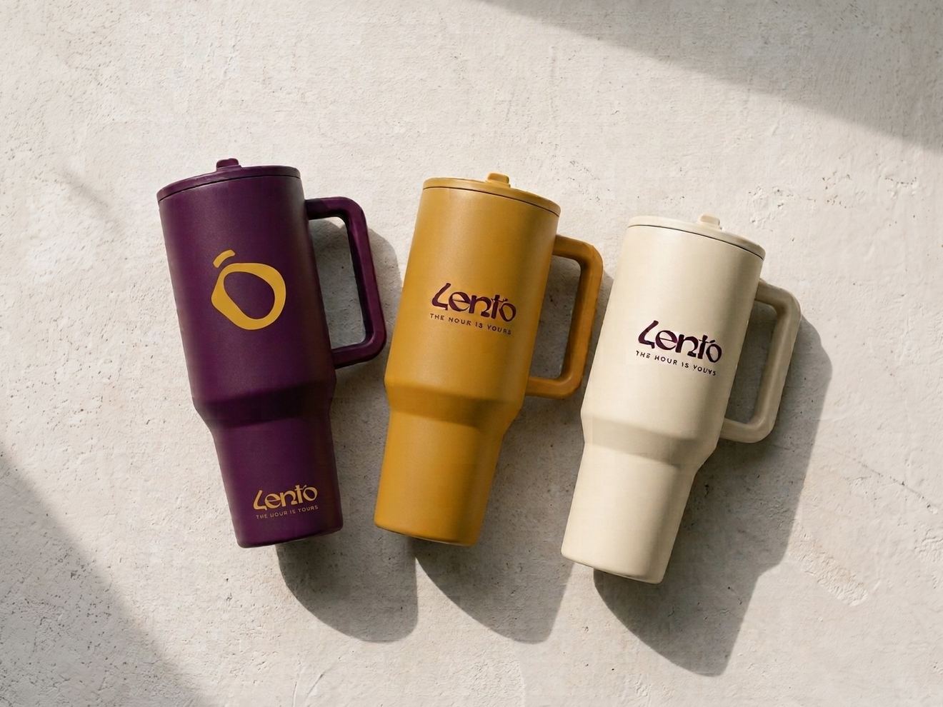 Three Lento thermos cups, plum, mustard and cream, from the front